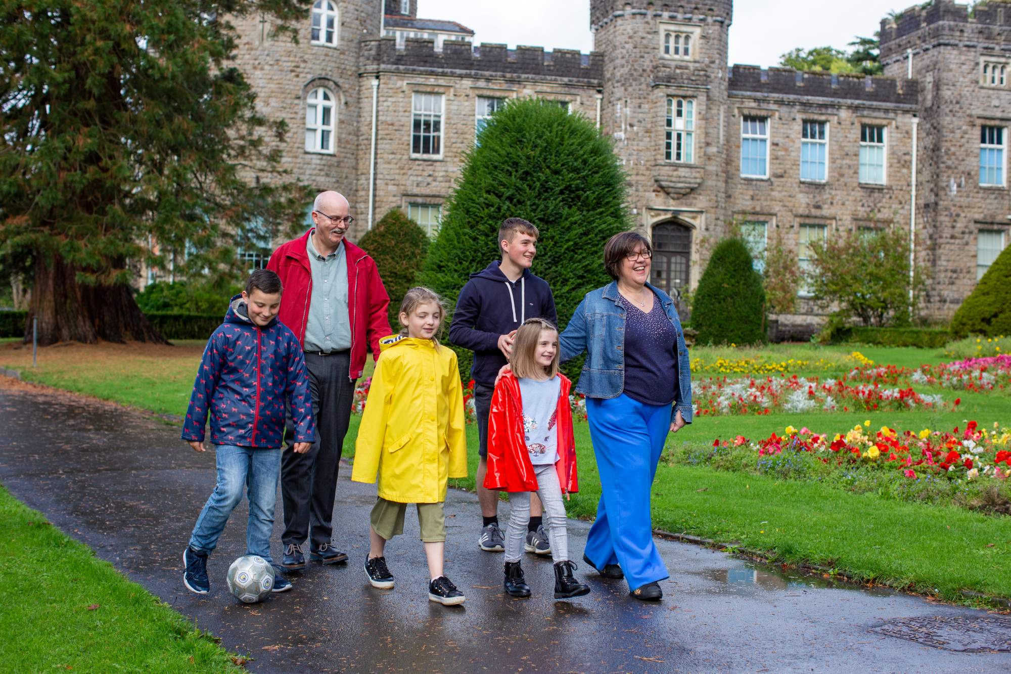 A family walking together in front of a castle