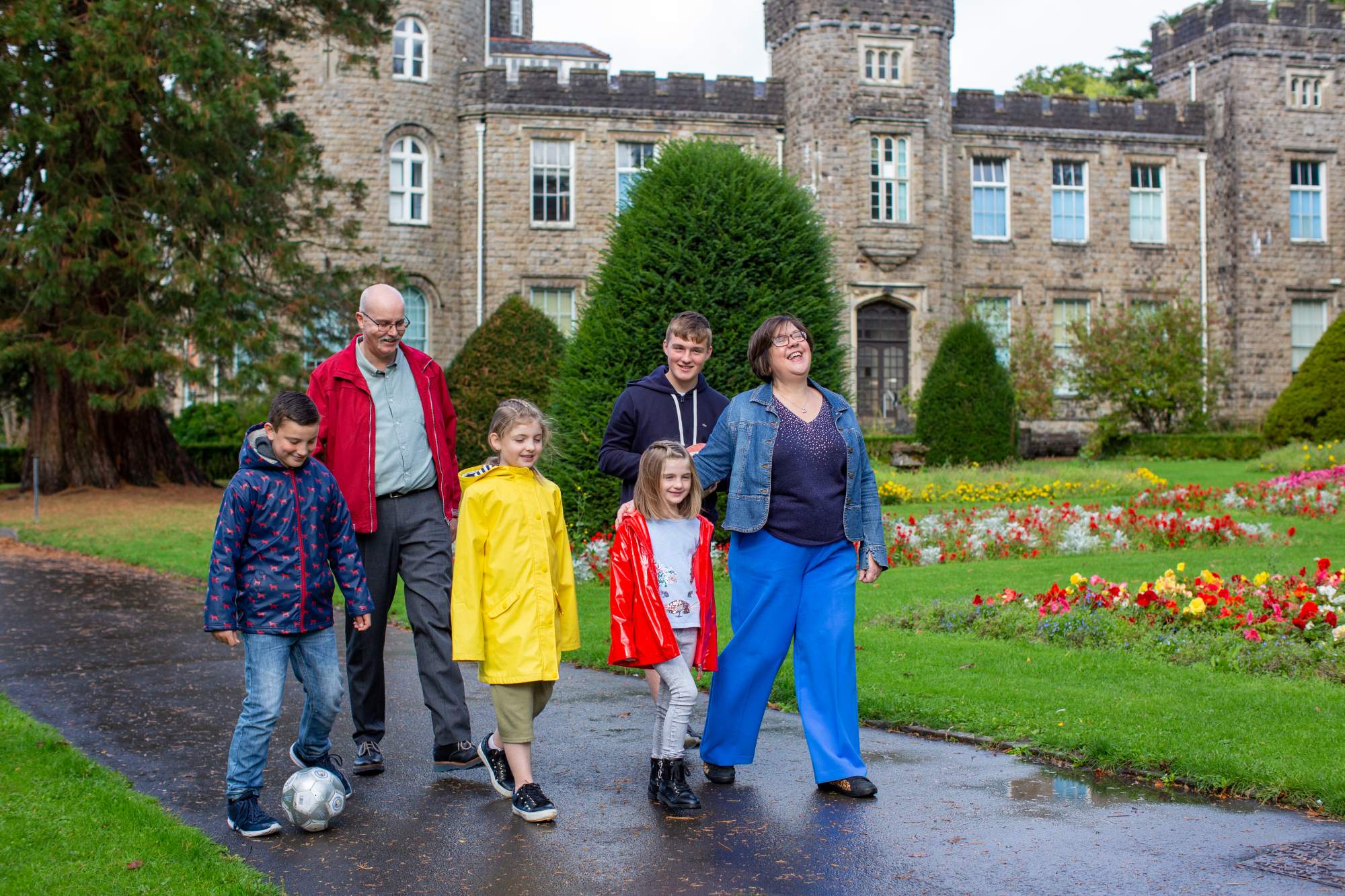 A family walking together in front of a castle