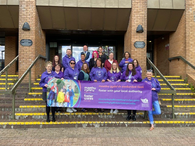 a group of people on the steps of the civic centre in Merthyr