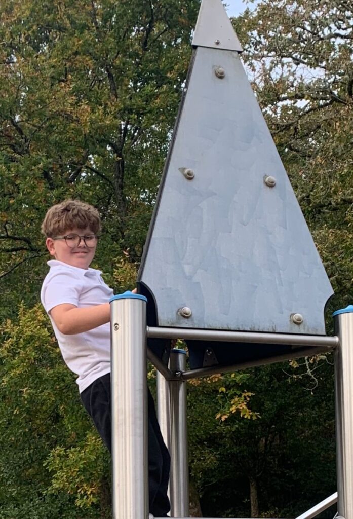 Alfie, child of foster carers climbing in Merthyr